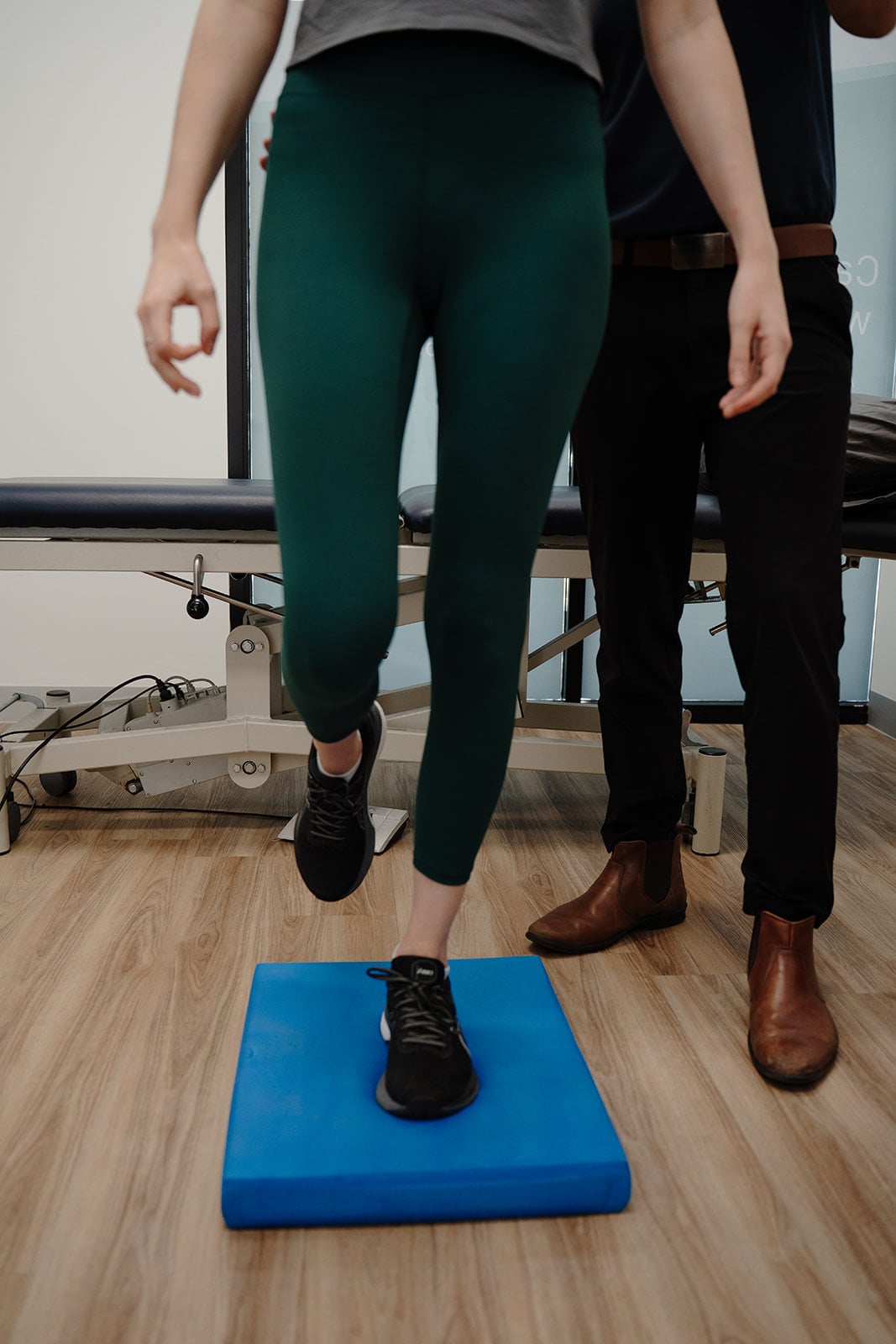A patient's feet on the balance pad