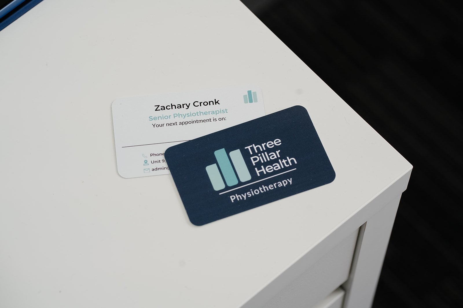 A Three Pillar Health appointment card on the reception desk