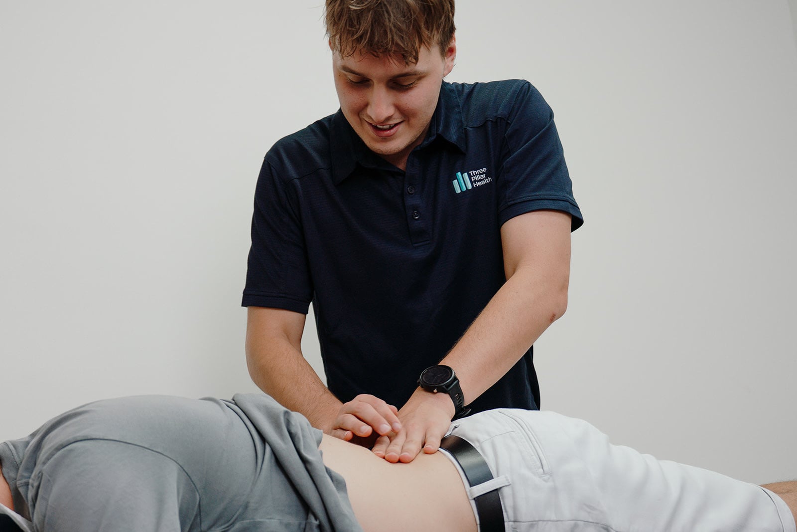 Jarred smiling while treating a patient's back
