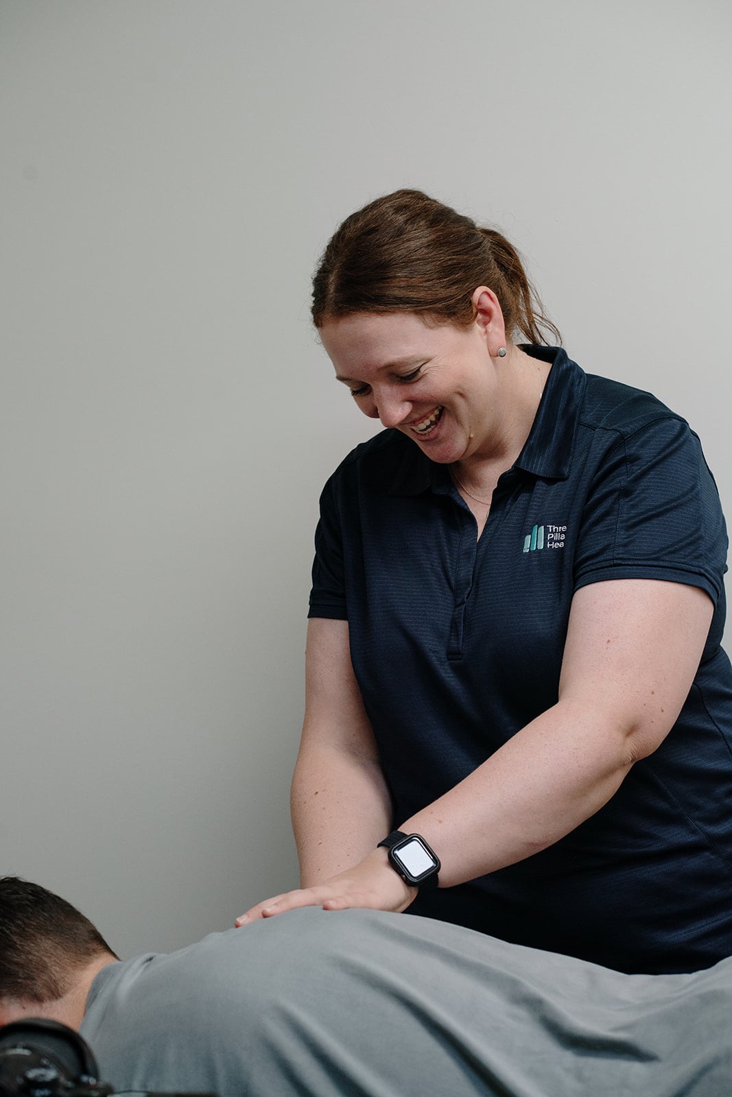 Kylie treating a patient's back