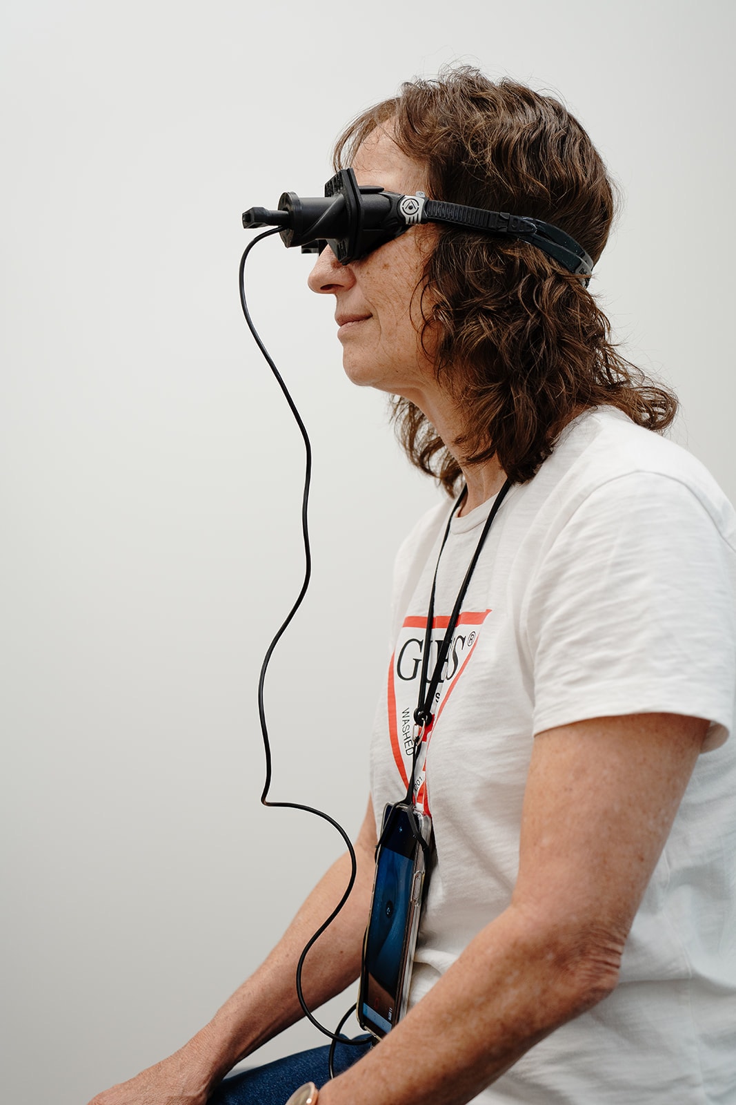 A patient in profile wearing the Vesticam goggles