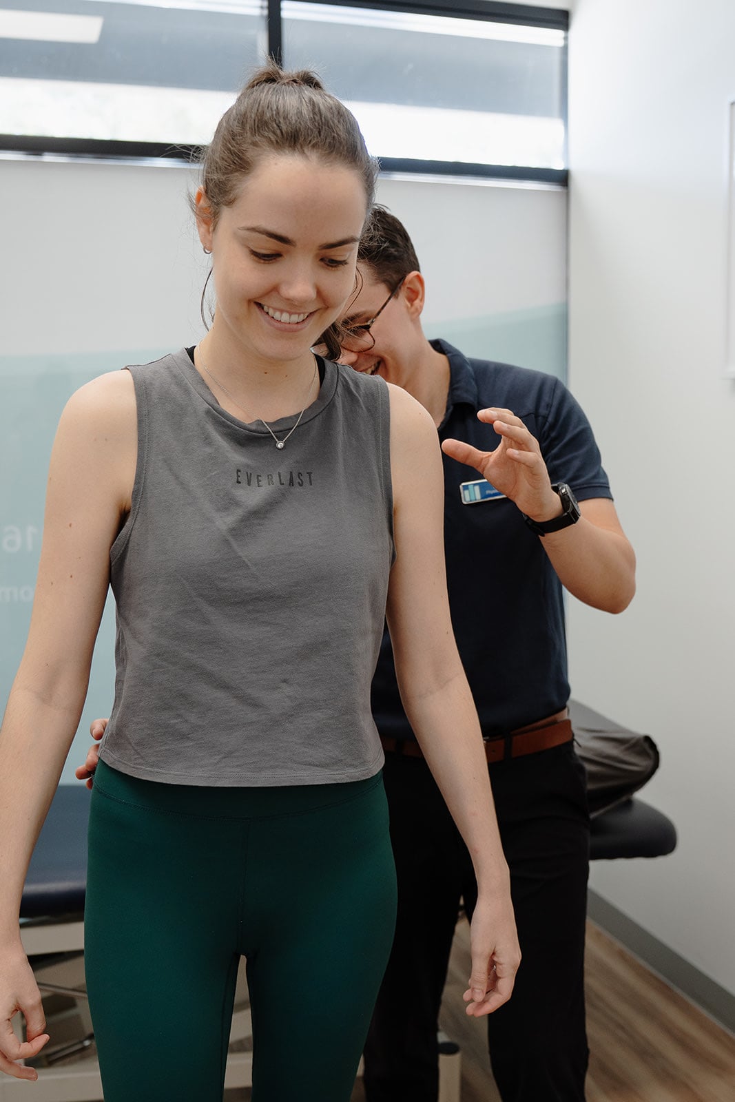 A patient balancing on the pad with Zac behind her